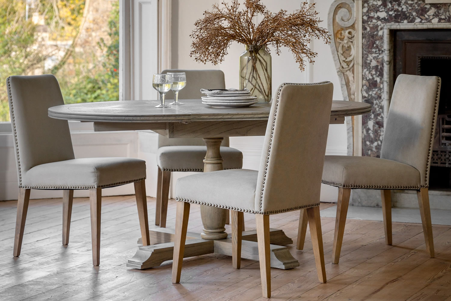 View Mustique Round Wooden Extending Dining Table Crafted From Mindi Ash MDF Spacious Round Tabletop Straight Spindle Legs Seats 46 People information