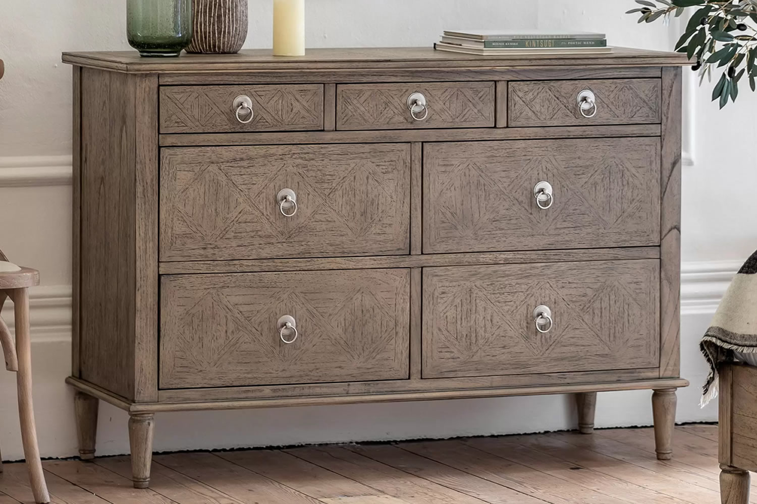 View Mustique Wooden 7 Drawer Storage Chest Made From Mindi Ash MDF 3 Small 4 Large Storage Drawers Metal Pull Handles Spindle Turned Legs information